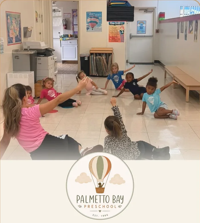 Preschoolers stretching with their teacher