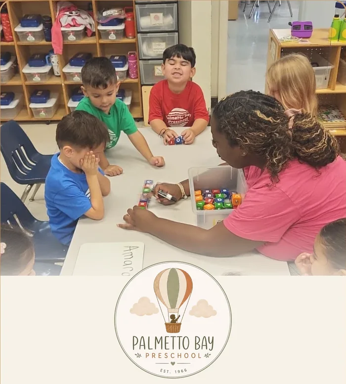 VPK students practicing letters with their teacher